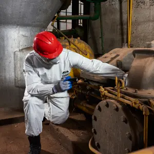 Industrial worker wearing MicroMax em428 from Lakeland Fire + Safety protecting from particulates